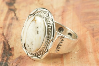 White Buffalo Turquoise set in Sterling Silver Ring. This Beautiful Stone is formed from the minerals Calcite and Iron. It is mined near Tonopah Nevada. Created by Navajo Artist Kathy Yazzie. Signed. 
